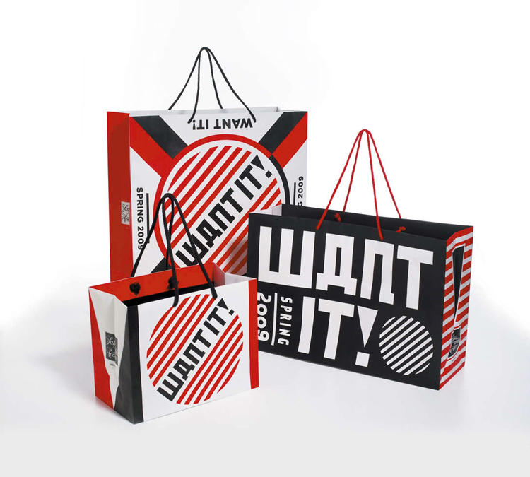 Red, black, and white striped shopping bags that say
